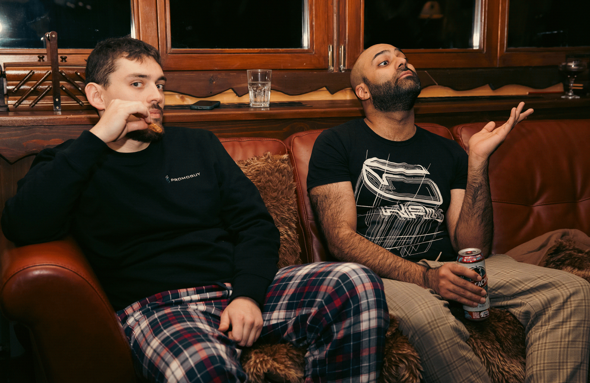 Two friends in a cozy indoor setting, having a deep conversation while sitting on a leather couch